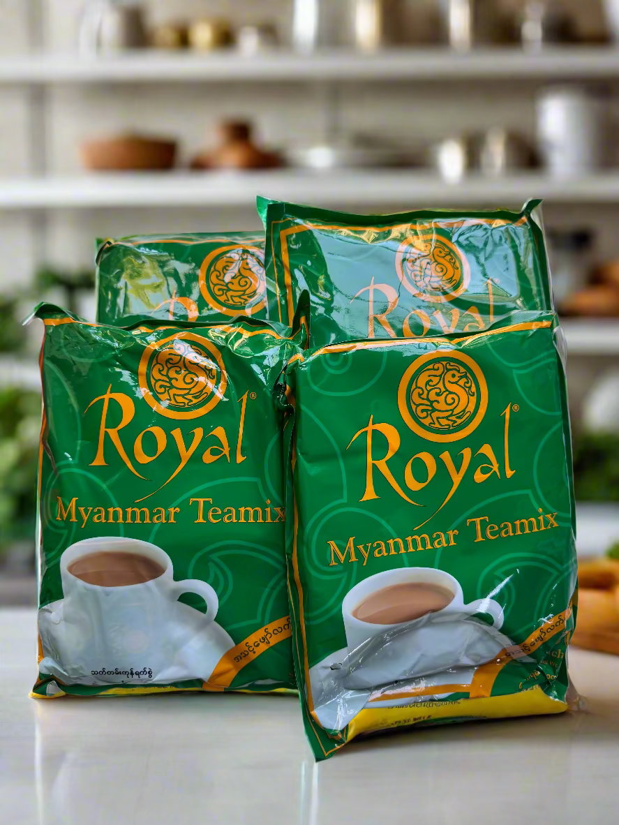 Three green packages of Royal Myanmar Teamix tea on a white surface.